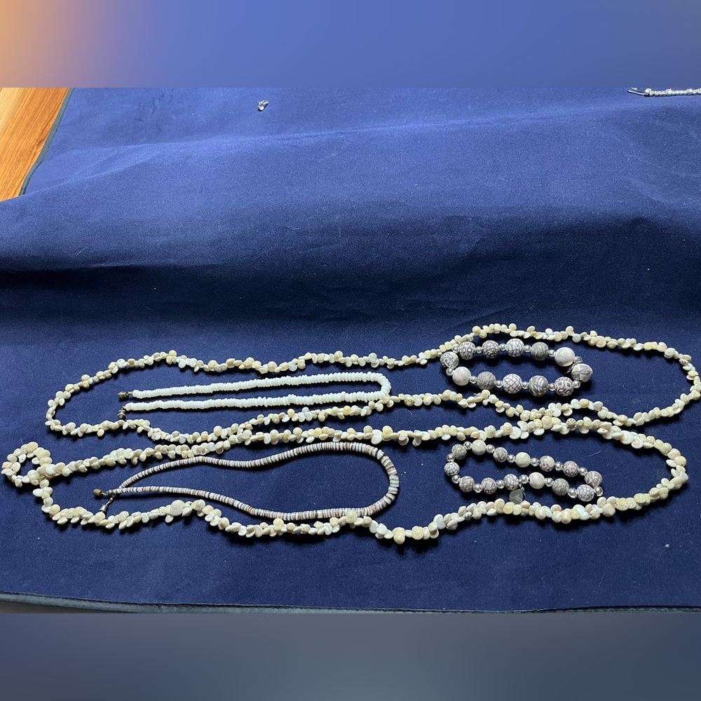 Vintage shell necklaces and bead bracelets.